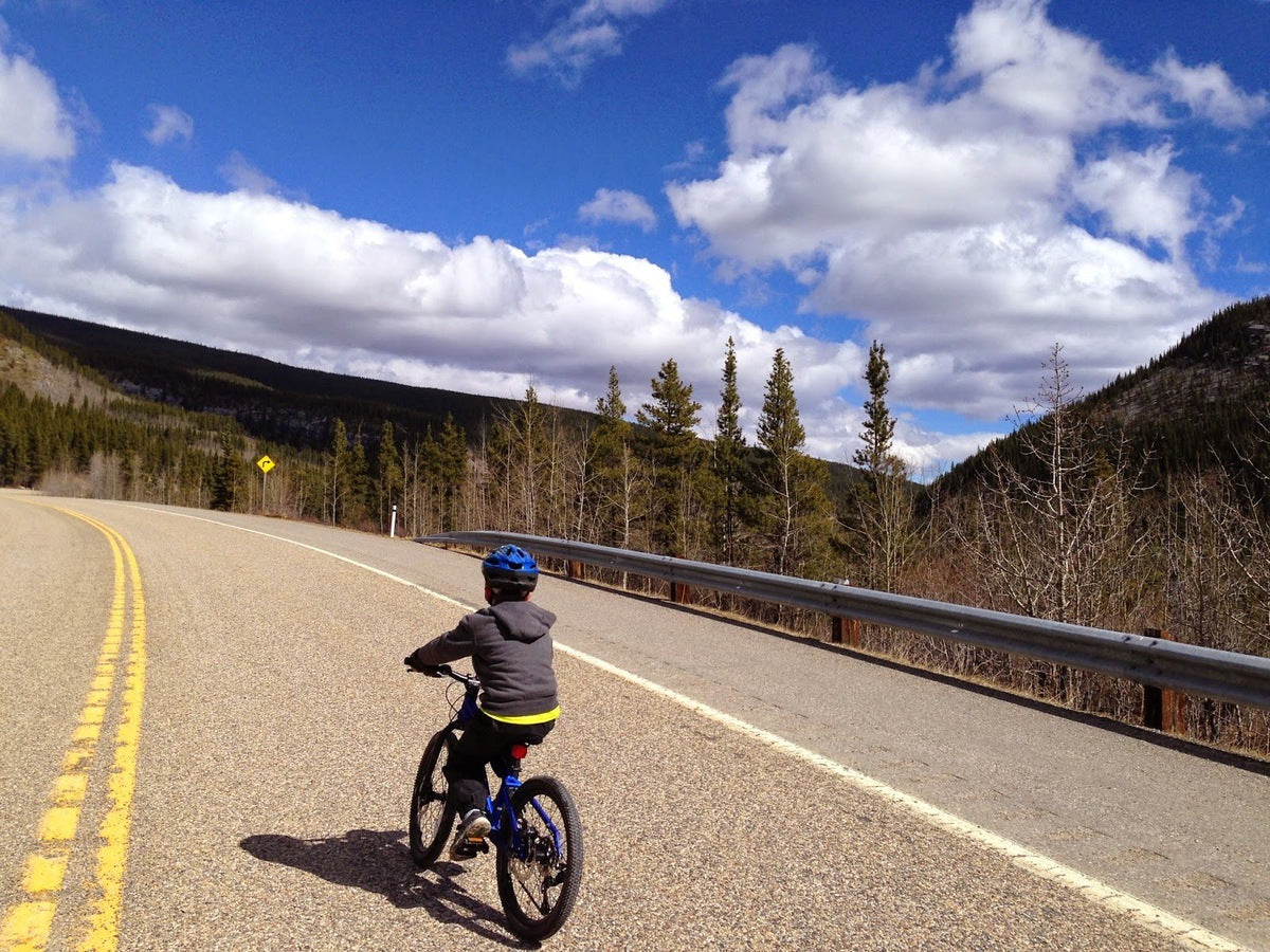 Kid biking Elbow River Valley bike route from Calgary