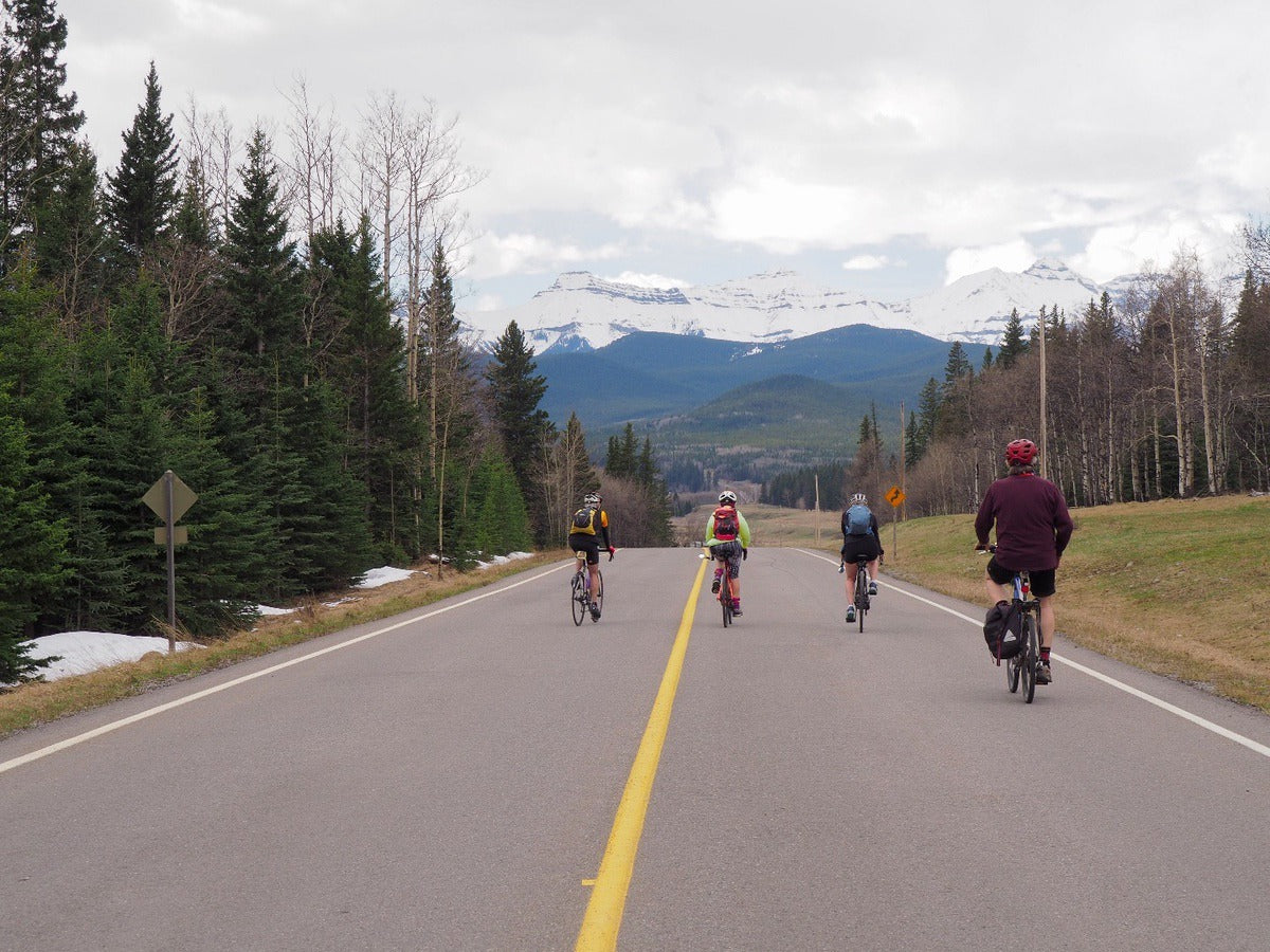 4 people biking the Sheep River Valley pathway from Calgary