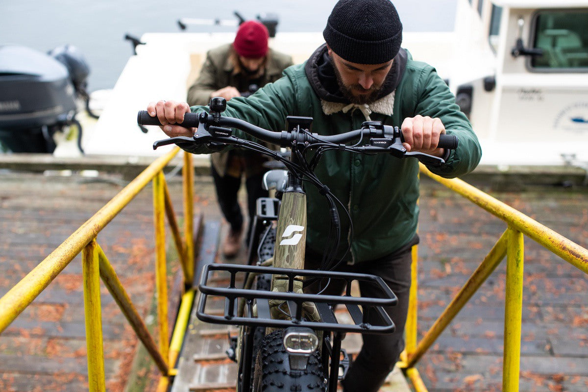 Cargo fat-tire eBike by Surface604 being pushed up ramp in city by rider